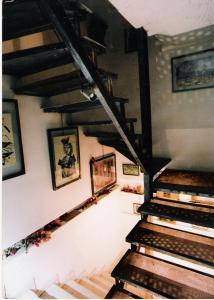 a staircase in a building with pictures on the wall at le mirador in Hammamet