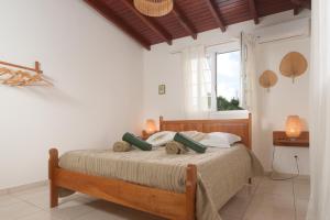 a bedroom with a bed and a window at Ô Bel Ter in Pointe-Noire +19 photos