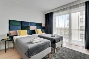 Posteľ alebo postele v izbe v ubytovaní Apartament Wałowa Stara Stocznia Gdańsk