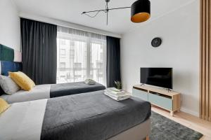 Posteľ alebo postele v izbe v ubytovaní Apartament Wałowa Stara Stocznia Gdańsk