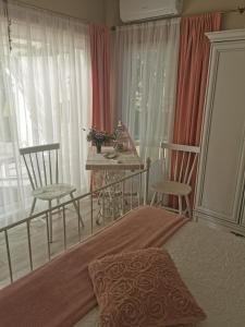 a bedroom with a bed and two chairs and a table at Holiday Home Kolka in Kolka