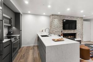 a kitchen with a sink and a fireplace at Little Nell Condo 03 in Aspen +23 photos