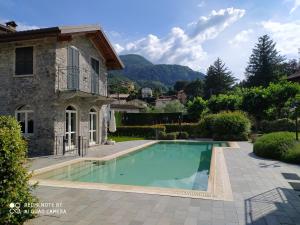 a swimming pool in front of a villa at BELLA VITA! in Bellagio