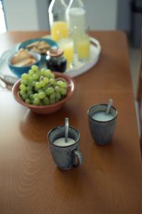 a table with two cups of milk and a plate of food at Sunset Home Crete in Paránimfoi