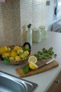 a counter with two baskets of lemons and limes on a cutting board at Sunset Home Crete in Paránimfoi