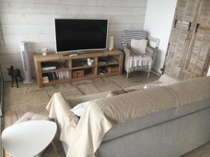 a living room with a couch and a flat screen tv at emplacement privilégié pour ce bel appartement in Agay - Saint Raphael