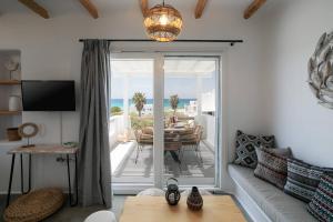 a living room with a sliding glass door to a patio at Villa Ester Naxos in Kastraki Naxou