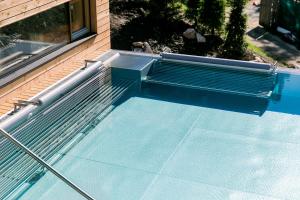 a swimming pool sitting next to a window at Hotel Gran Paradiso in San Cassiano