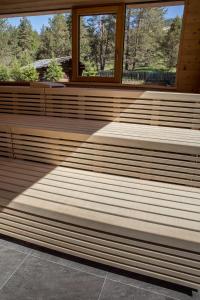 a row of wooden benches in a building at Hotel Gran Paradiso in San Cassiano