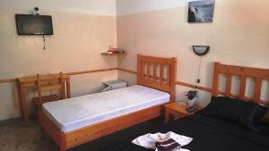 a small bedroom with a bed and a couch at Pousada Villa Concetta in Cidade Velha