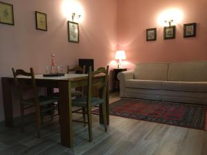 a living room with a table and a couch at Corte San Giuliano in Correzzola