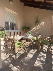 a patio with a table and chairs on a patio at Apartman Dalija in Vinkuran