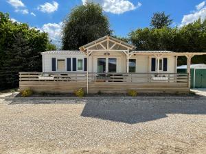 a house with a wooden fence in front of it at détente au cœur de la ferme in Lacroix-sur-Meuse