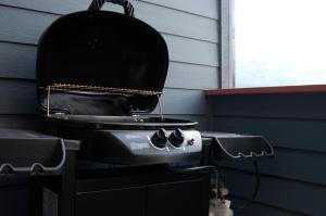 a grill sitting on top of a house at Apartment 407, Contemporary Decor in Canmore