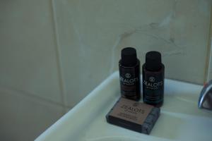 two bottles of hair products sitting on a bath tub at Sunset Home Crete in Paránimfoi