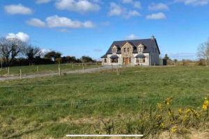 a large house in the middle of a field at Annies Meadow. in Knock