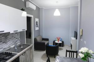 a kitchen with a sink and a living room at Casa Mitch in Catania +3 photos