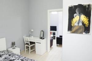 a bedroom with a bed and a desk with bananas at Casa Mitch in Catania