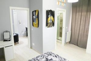 a room with three paintings on the wall at Casa Mitch in Catania