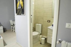 a bathroom with a toilet and a sink at Casa Mitch in Catania