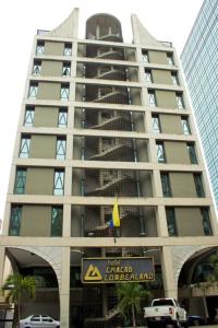 a tall building with a sign in front of it at Hotel Chacao Cumberland in Caracas