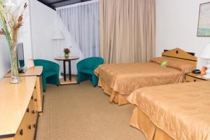 Postel nebo postele na pokoji v ubytování Hotel Chacao Cumberland + 12 fotografií