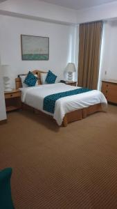 En eller flere senge i et værelse på Hotel Chacao Cumberland