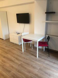 a white table and two chairs in a room at Beside Airport in Otopeni