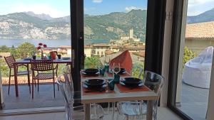 a table and chairs with a view of a balcony at Blue Sky Garda - Sunset in Malcesine