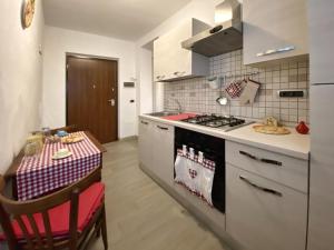 a kitchen with a stove and a table in it at B&B Lunetia in Castelnuovo Magra +18 photos