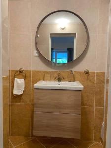 a bathroom with a sink and a mirror at Apartmán Klára in Terchová