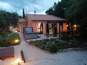 a small house with a bench in front of it at The Forest House Krk 2 in Kras