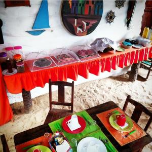 una mesa con un mantel rojo encima en Pousada JeriMagia en Jericoacoara
