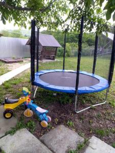 a trampoline in a yard with a childs toy at Private House in Berehove