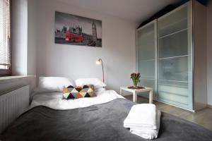 a bedroom with a large bed and a window at Airport Okecie Klobucka P&O Serviced Apartments in Warsaw