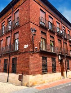 - un bâtiment en briques avec des balcons sur le côté dans l'établissement Apartamento The Wall Xperience, à León
