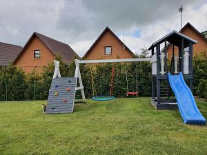 a playground with two slides and a swing at A&M Apartamenty in Łukęcin