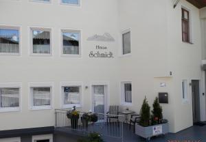 a white building with a sign that reads has admired at Haus Schmidt in Berchtesgaden