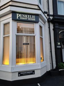 a store front with a sign for a guest house at The Penkelie in Southport