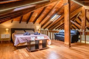 a bedroom with a bed and a table and a chair at Sunshine House Corfu in Anemómylos