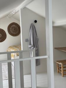 a room with white walls and a staircase with a mirror at vakantiehuis Cerise, Luxueus genieten in de Leiestreek in Deinze