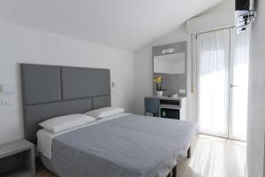 Postel nebo postele na pokoji v ubytování Hotel Eugenio