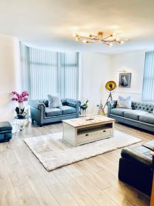 a living room with couches and a coffee table at Monopoly Holiday Home in Blackpool