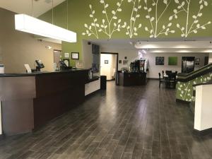 a lobby of a store with a cashier and a counter at Sleep Inn Raleigh Durham Airport in Durham