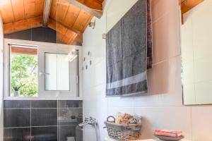 a bathroom with a sink and a toilet and a window at Sunshine House Corfu in Anemómylos +35 photos