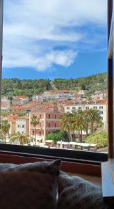 a window with a view of a city with palm trees at Apartment Lilly with Amazing City View in Hvar