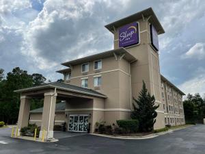 a hotel building with a sign on top of it at Sleep Inn Raleigh Durham Airport in Durham