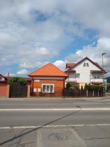 a house on the side of the road with a street at Olimpia Apartments in Alba Iulia