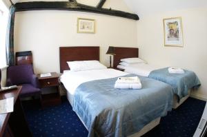 Un pat sau paturi într-o cameră la The George & Horn near Newbury