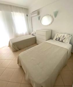 a bedroom with two beds and a mirror at Квартира рядом с морем in Kemer